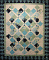Jessica's Quilt was created by S. Cully. Pattern from Book Take 5 - Crosses the Line by Kathy Brown. Party Dress fabric by Mo Bedell for Blue Hill.